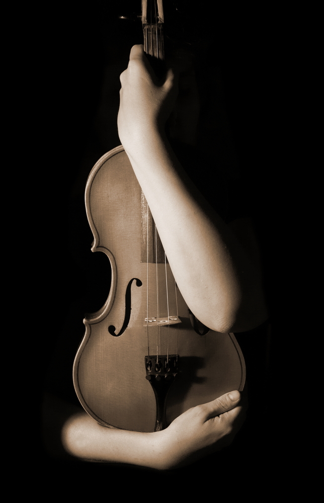 arms entwining an old violin