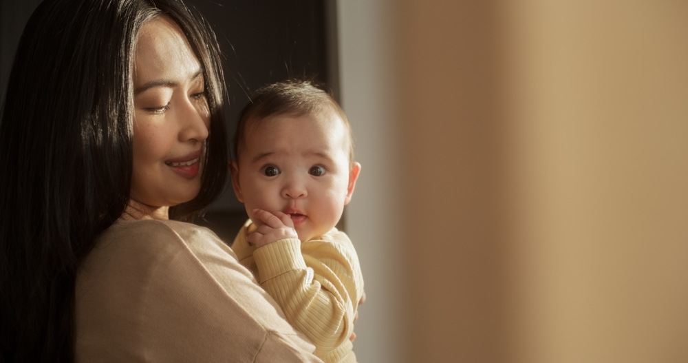 Asian Woman Holding her Baby in her Arms