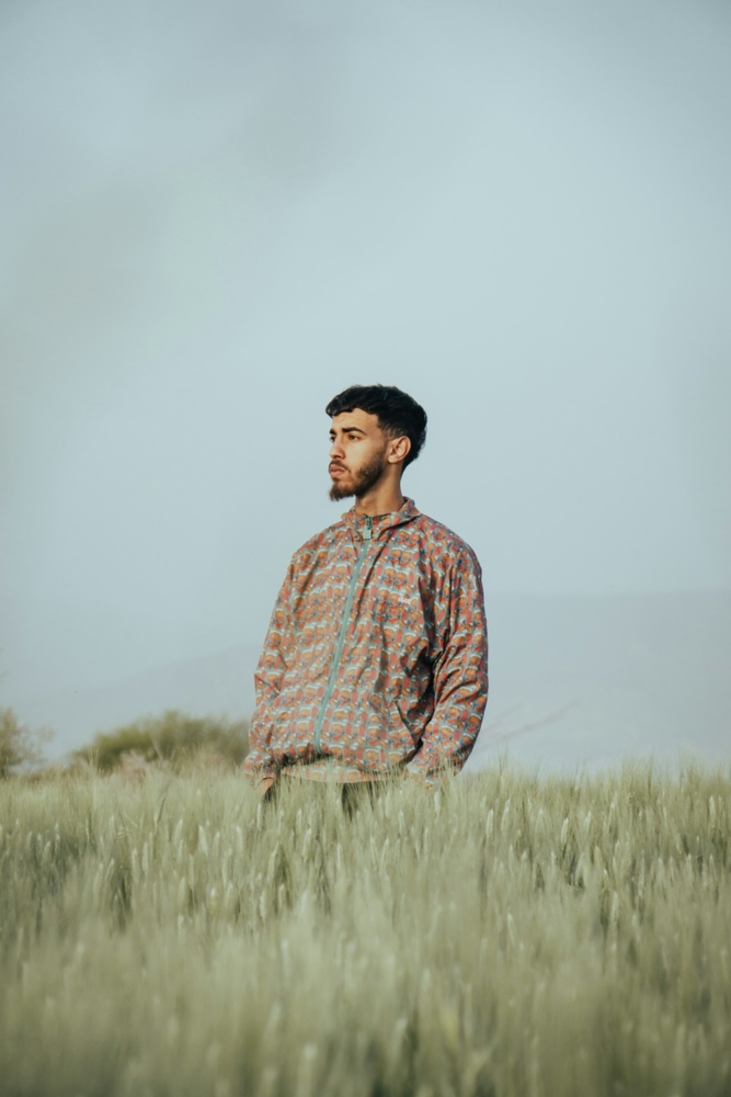 man standing in a field of tall grass