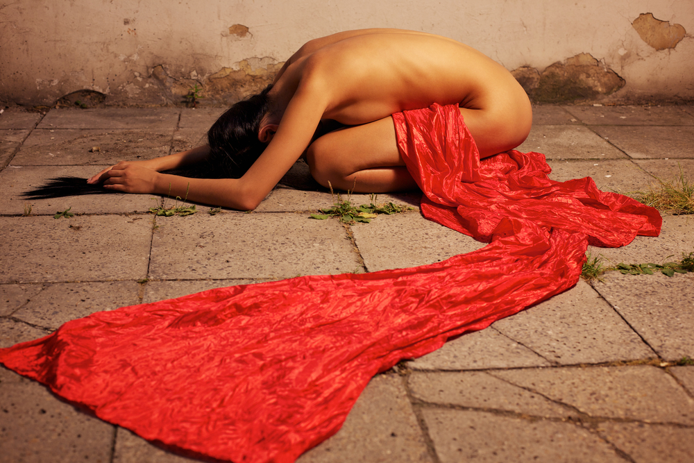 Nude woman with red fabric