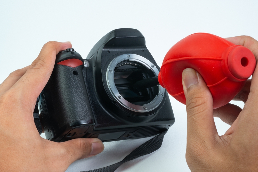 photographer cleaning camera