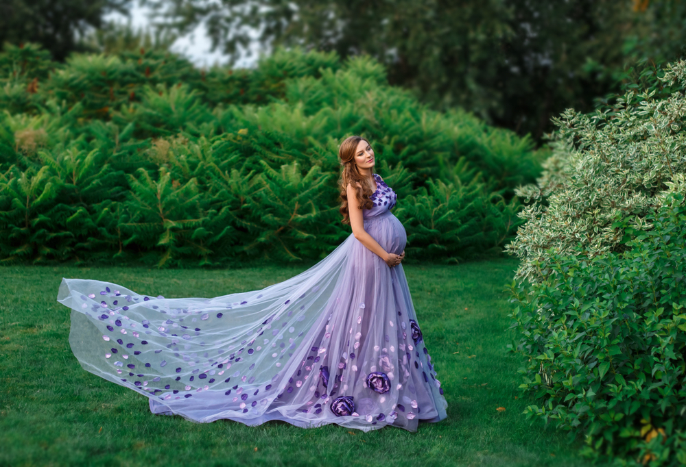 Pregnant woman wearing a purple dress