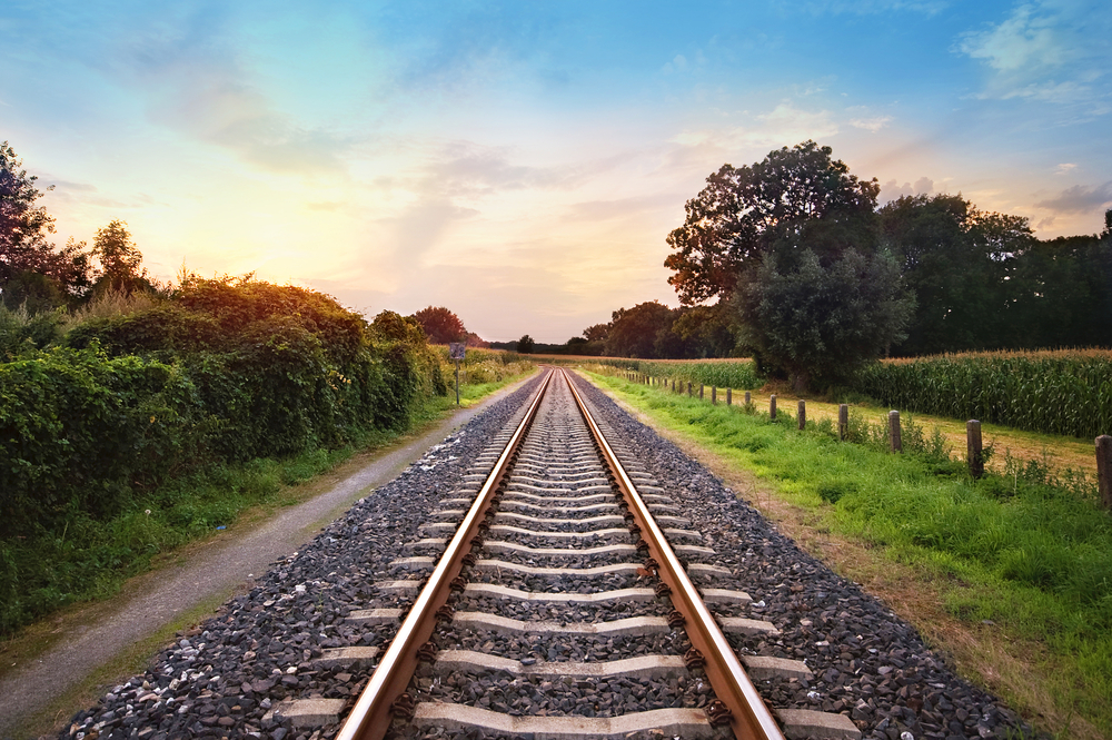 railway tracks in a rural scene with nice pastel sunset