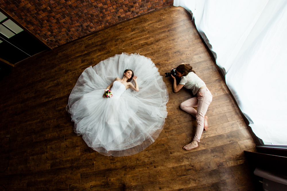 Wedding Photographer with bride on the floor