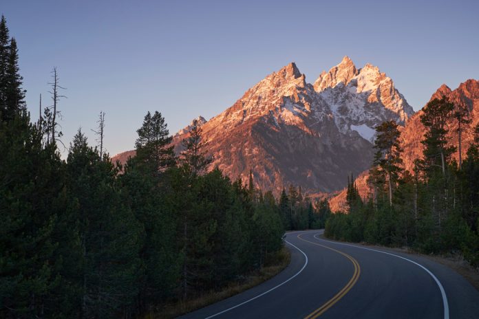 Winding road through mountain landscape, Grand Teton National Park, Wyoming, USA
